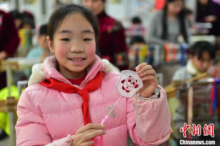 圖為一名小學生繡制的2022年北京冬奧會吉祥物“冰墩墩”形象。　喻云亮 攝
