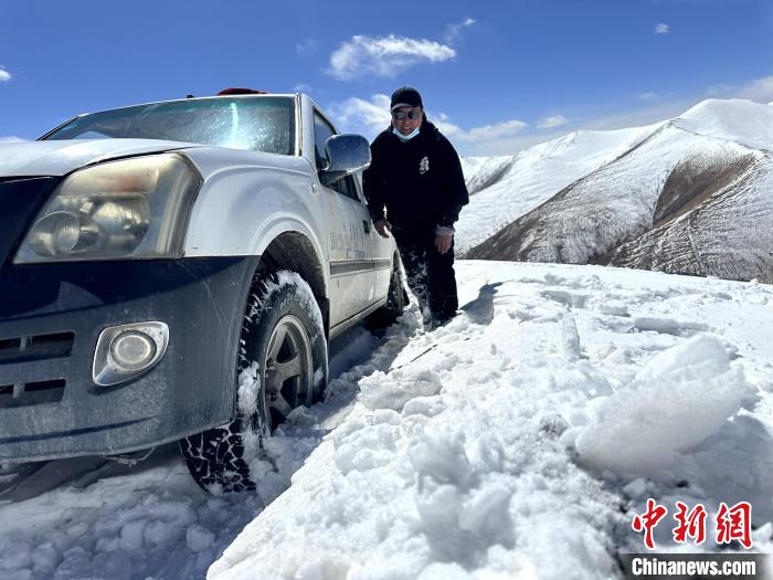 圖為生態(tài)管護人員準備在雪地推車?！《“瓦_杰 攝