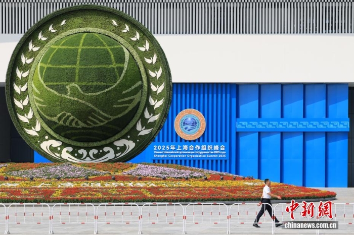 8月31日，天津，一名工作人員從2025年上海合作組織峰會主會場外的景觀花壇旁經(jīng)過。當(dāng)日，2025年上海合作組織峰會在天津舉行。<a target='_blank' href='/'><p  align=