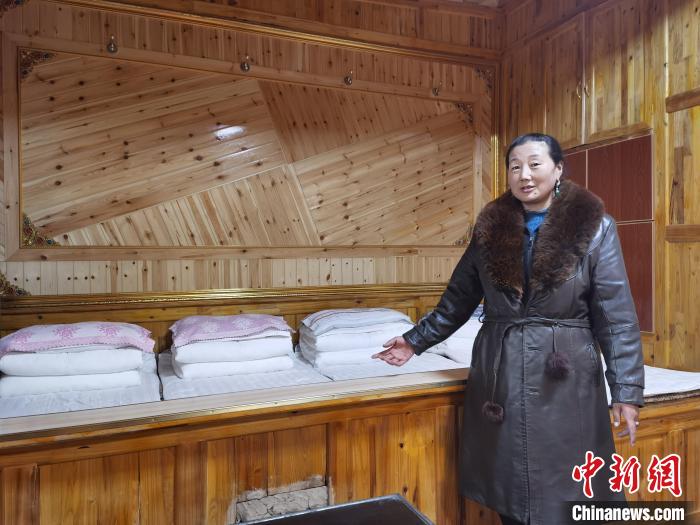 圖為德吉村村民鬧尖措介紹自家農(nóng)家樂?！∑钤鲚?攝