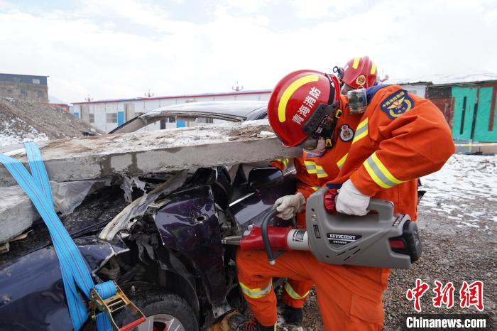 圖為地震實(shí)戰(zhàn)拉動(dòng)現(xiàn)場(chǎng)，參演人員進(jìn)行車輛破拆。　玉樹消防供圖