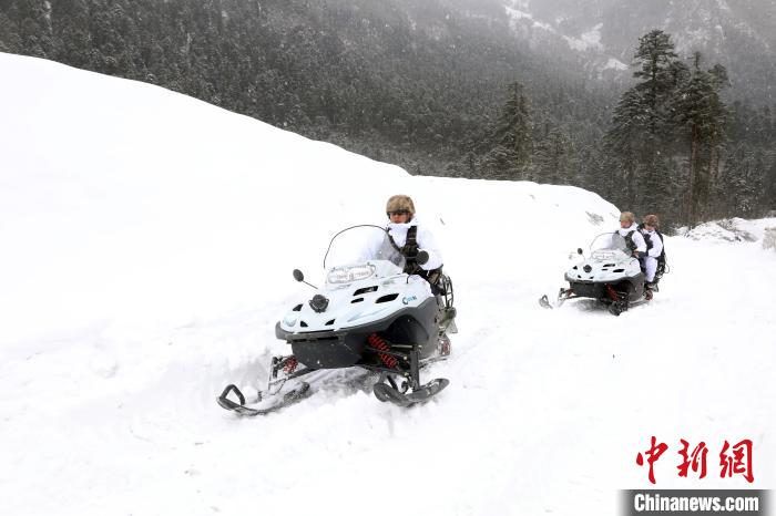圖為雪地摩托車開路。　薛金博 攝