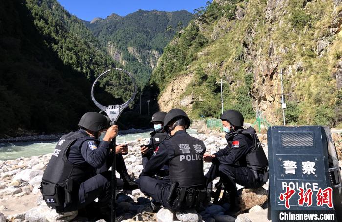 圖為西藏吉隆出入境邊防檢查站移民管理警察在中尼邊境巡邏途中收看二十大開幕直播。　郭章統(tǒng) 攝
