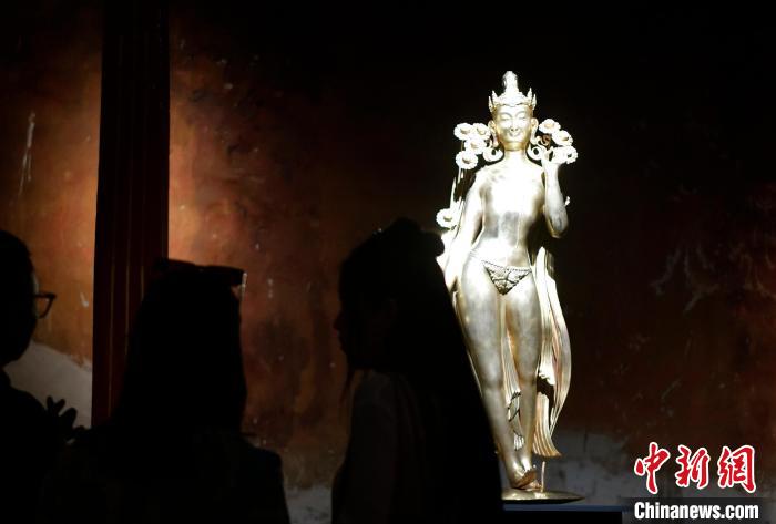 圖為觀眾正在欣賞展覽中的雕塑作品《八萬四千年》?！±盍?攝