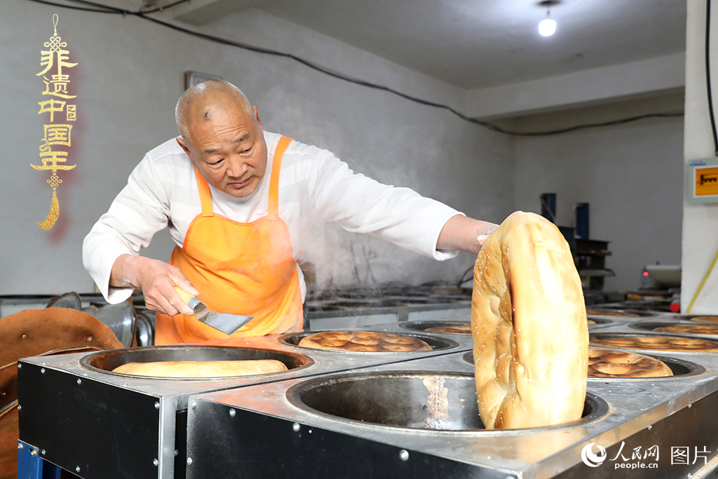 2025年1月23日，山東省臨沂市莒南縣一家傳統(tǒng)大餅作坊內(nèi)，師傅們正忙著烤制當(dāng)?shù)厝舜汗?jié)期間家家戶戶必備的、金黃誘人的莒南大餅。人民網(wǎng)記者 劉祺攝